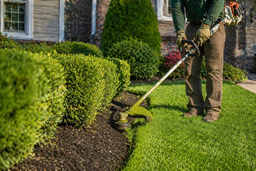 Blowing grass clippings off driveway after lawn service in Riverton Utah
